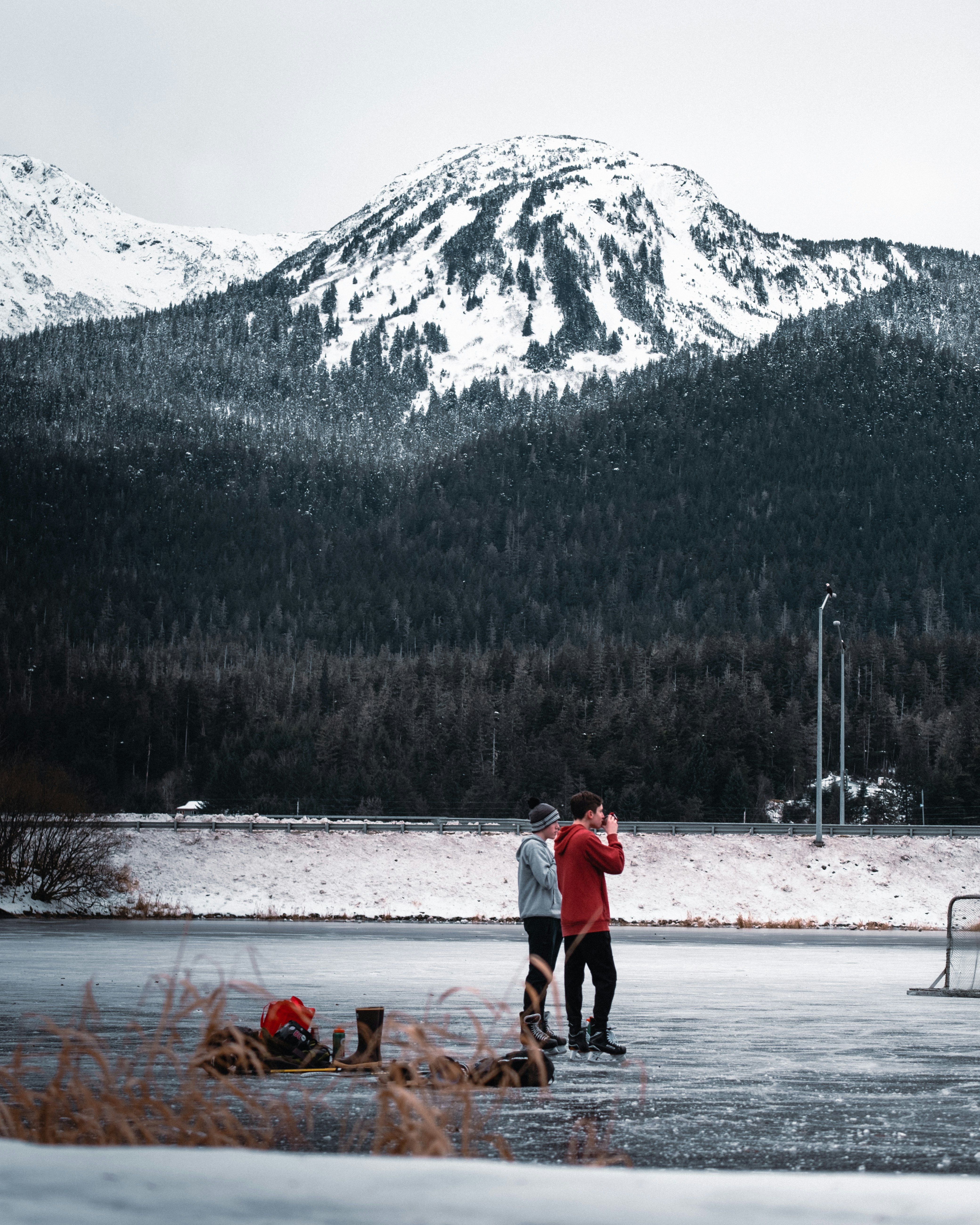 man and woman walking on snow covered ground during daytime